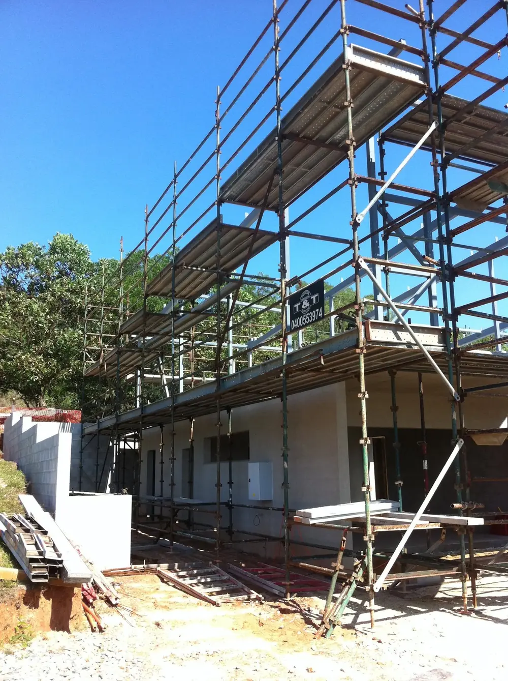 Scaffolding erected around a two-storey building under construction